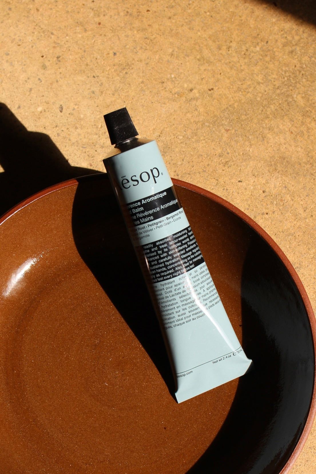 Aesop Reverence Aromatique Hand Balm on terracotta dish
