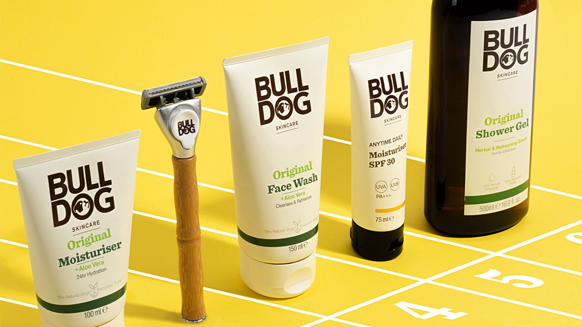 Bulldog Original moisturiser, bamboo razor, face wash and shower gel on yellow track