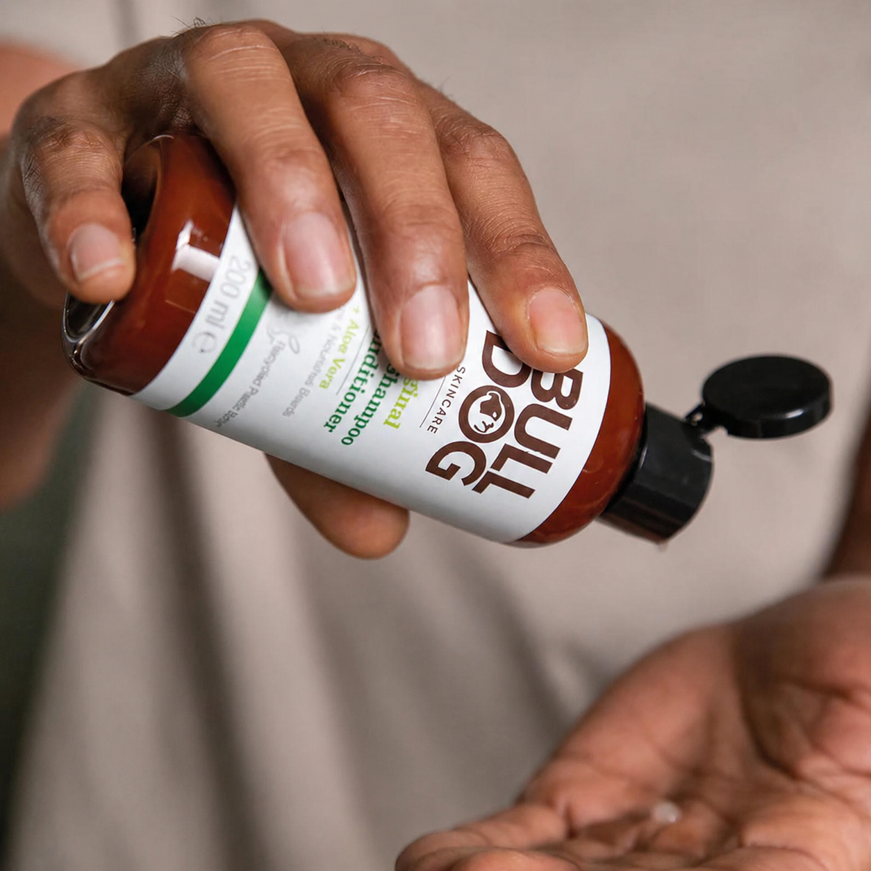 A man pouring Bulldog into his hand — the product in use