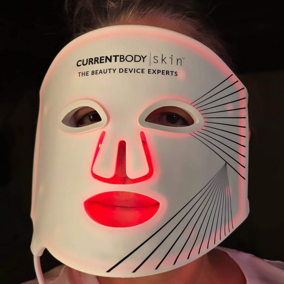 CurrentBody Skin LED Mask Series 2 close-up — the red-light glow on skin in clinical detail