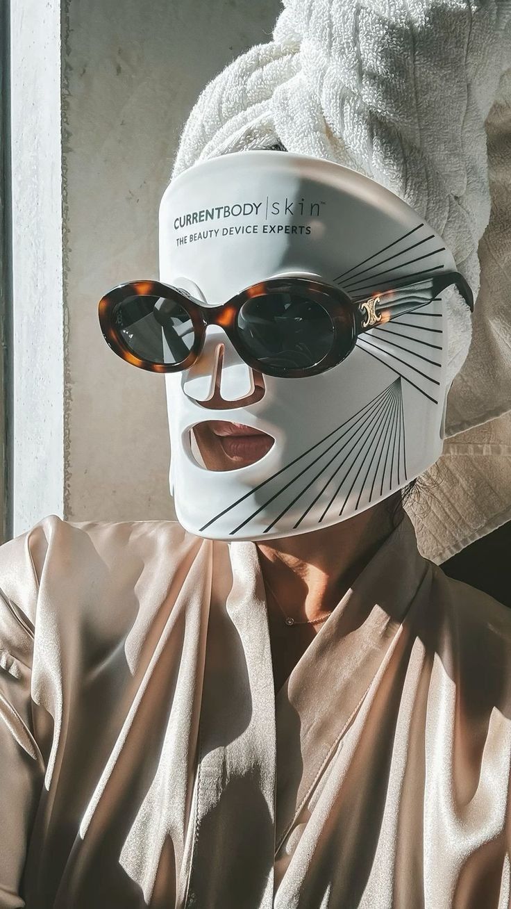 CurrentBody Skin LED Mask worn with hair towel and silk robe — the at-home ritual