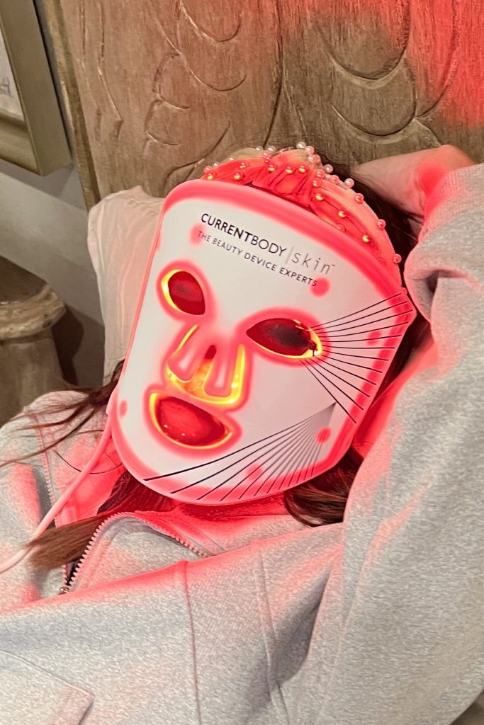 CurrentBody Skin LED Mask styled with pearl headband — flexible silicone glow