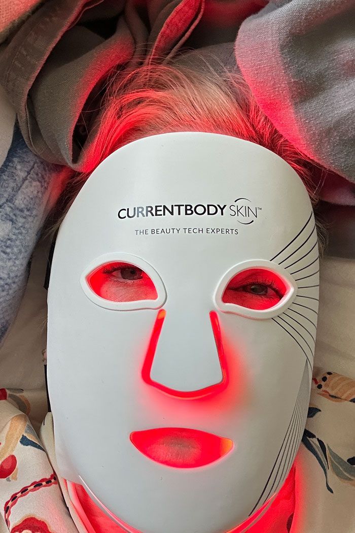 CurrentBody Skin LED Mask mid-treatment — red-light glow during evening session