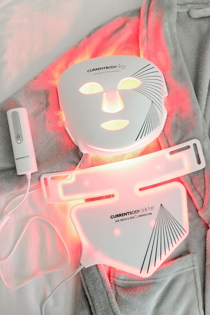 CurrentBody Skin LED Neck & Dec Perfector flatlay with mask on robe