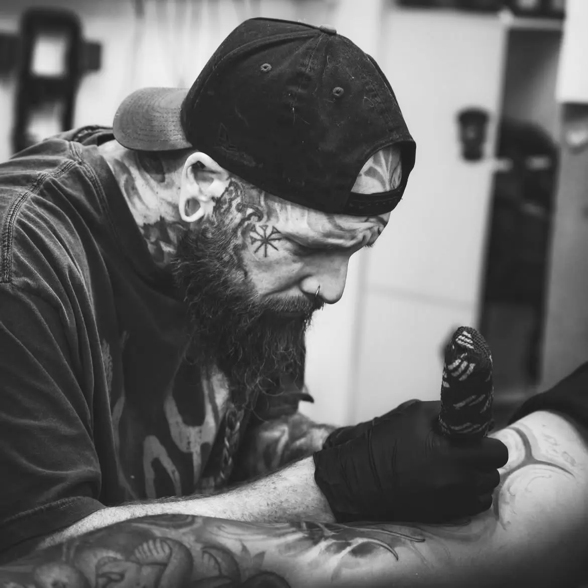 Tattoo artist working on sleeve