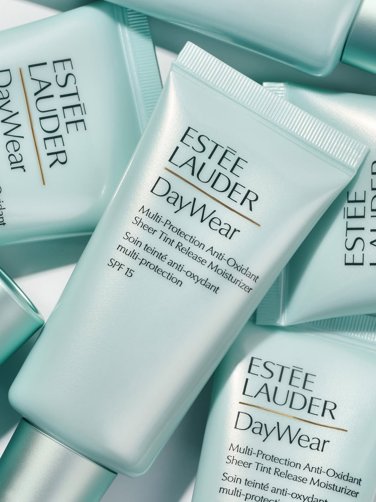Estée Lauder DayWear teal tubes scattered flatlay