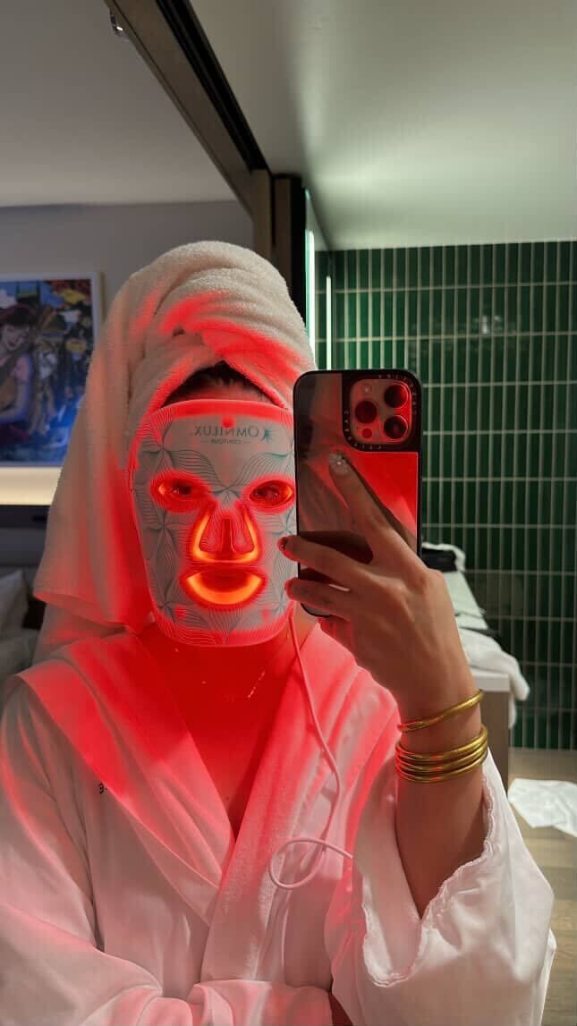 Omnilux Contour Face user in robe with mask active