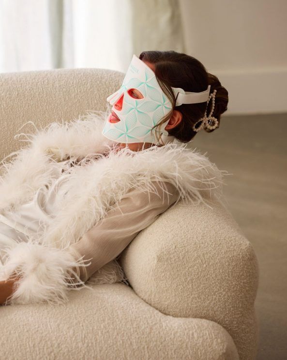 Omnilux Contour Face lifestyle — feather robe and the mask as ritual