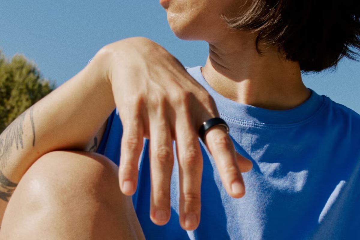 Oura Ring app — sleep score and readiness on a phone, bedside