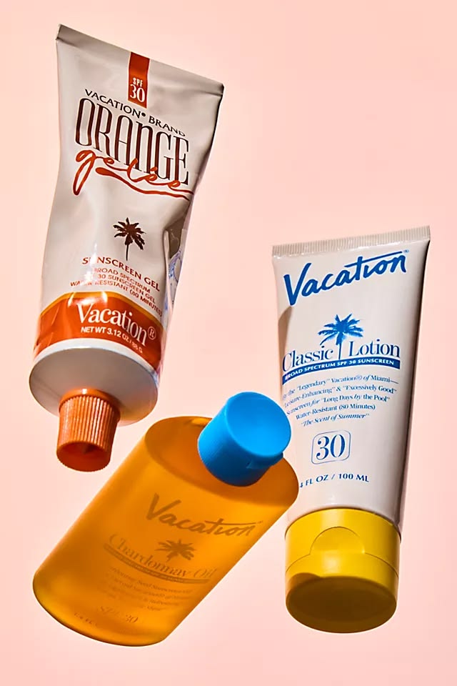 Vacation Orange Gelee, Classic Lotion and Chardonnay Oil flatlay on pink