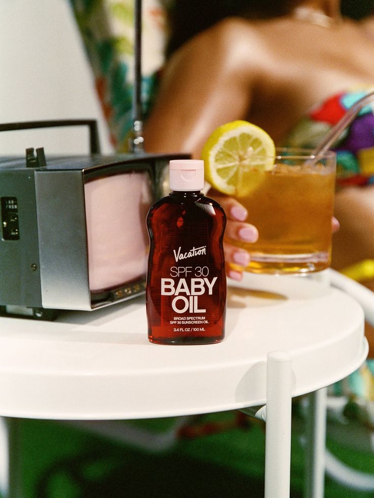 Vacation Baby Oil SPF 30 with retro TV and citrus drink — campaign still