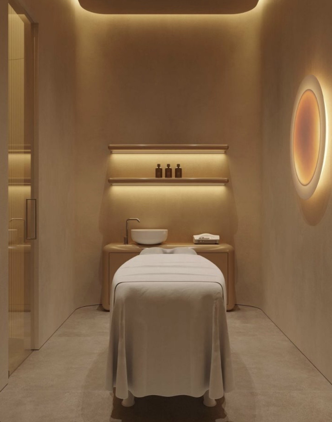 Minimalist skin treatment room with warm light and stone treatment bed
