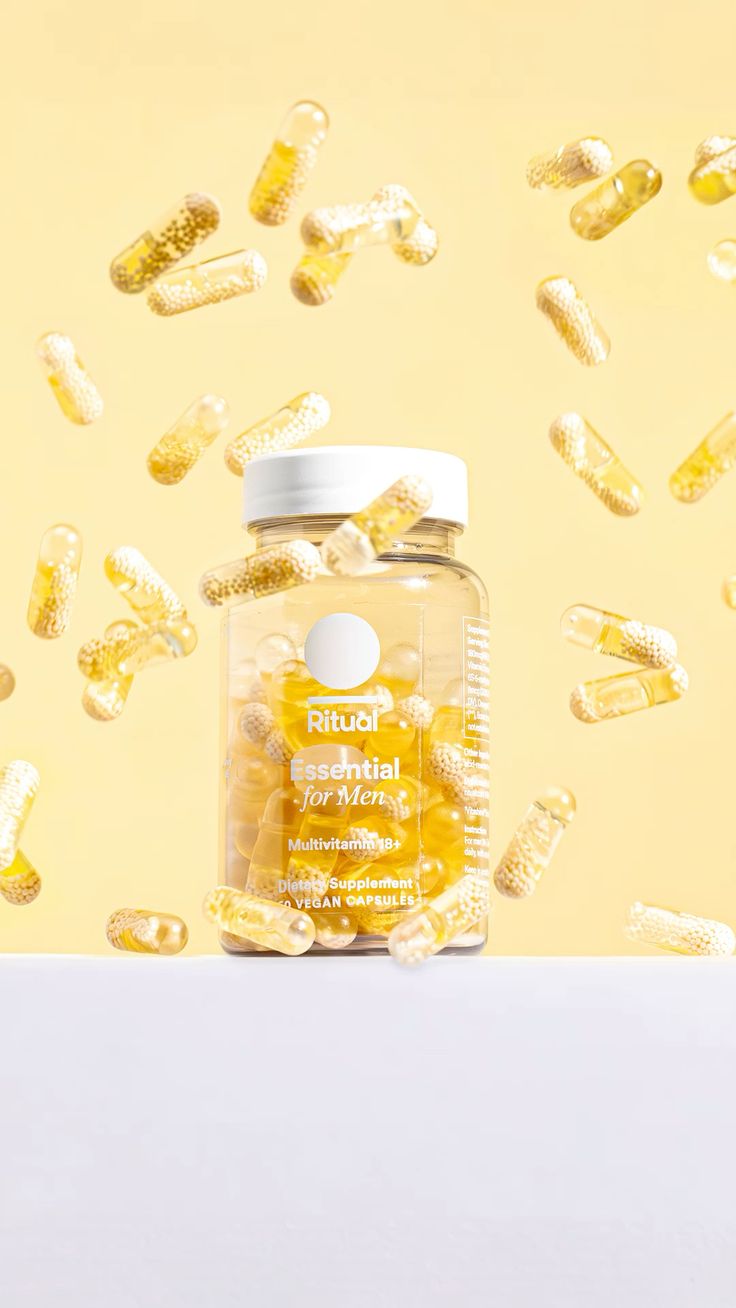 Supplements editorial — multivitamin held against capsule cloud
