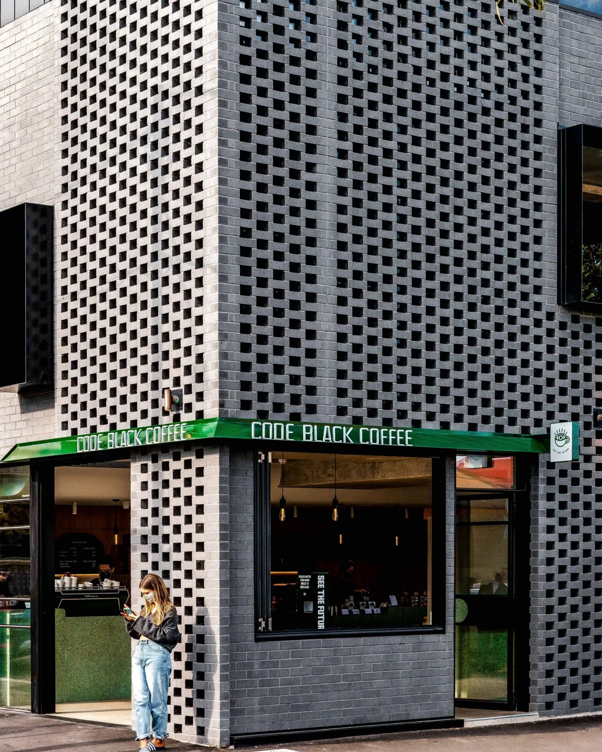 The building on its corner, with the cafe below