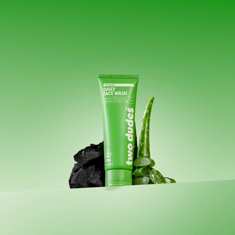 Two Dudes Daily Face Wash, a green tube with charcoal and aloe vera ingredients shown alongside.